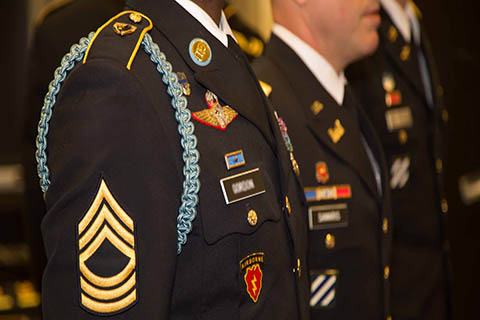 This is a close up photo of the an army officer's formal uniform. 